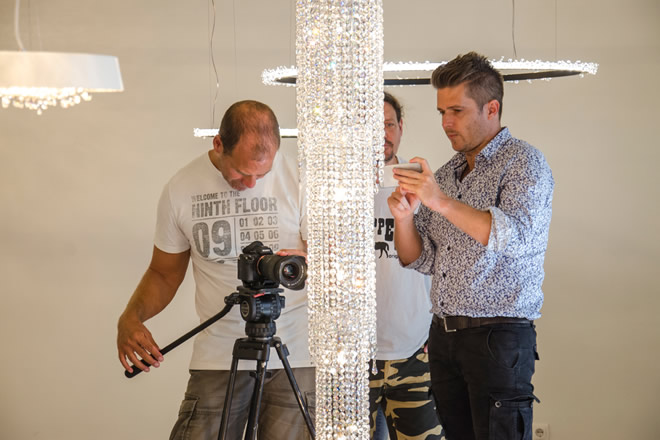 manooi-fjord-tv2-crystal-luxury-design-hungarian-brand-csaba-gyetván The filmmaking crew adjusts the camera and lights around a Fjord crystal chandelier for an interview video shoot on TV2.