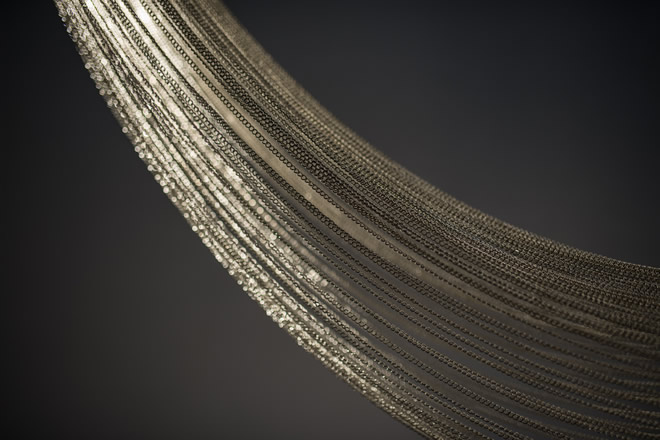 Close-up of luxury crystal strands in a high-end lighting fixture.